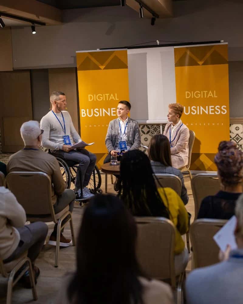 Business people on a panel discussion at a convention center