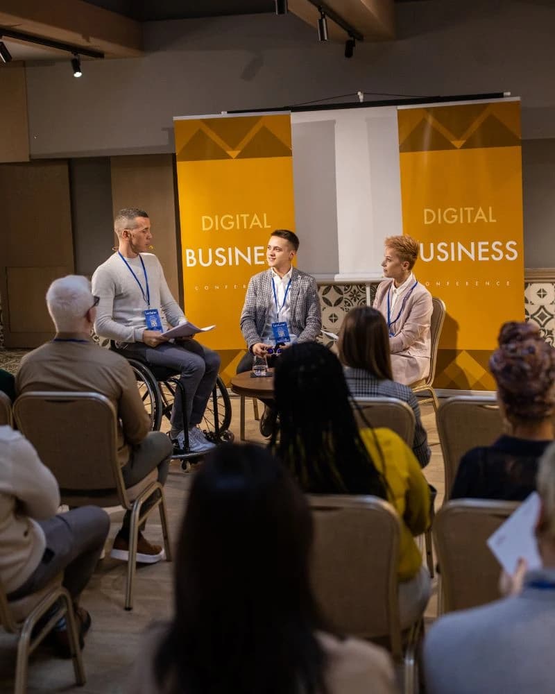 Business people on a panel discussion at a convention center